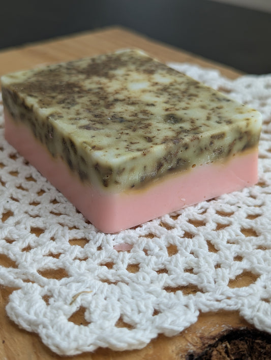 Bar of soap with a pink and brown pattern on a white lace doily