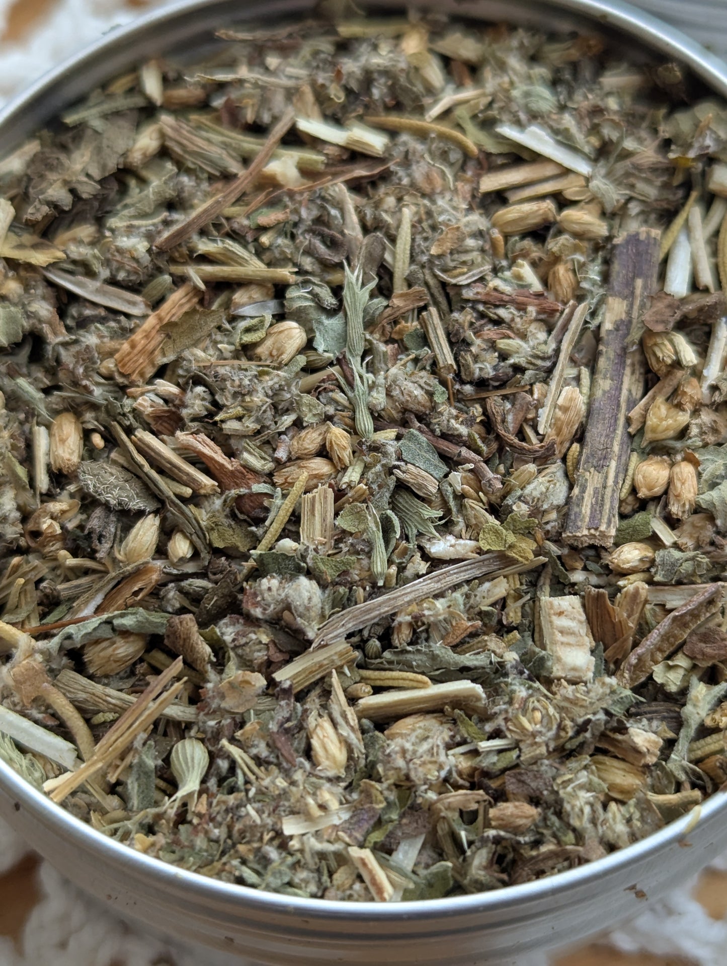 Close-up of dried herbs in a metal container