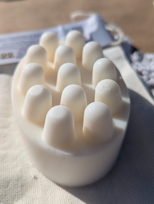 White solid shampoo and conditioner hair care soap bar with rounded massaging ends